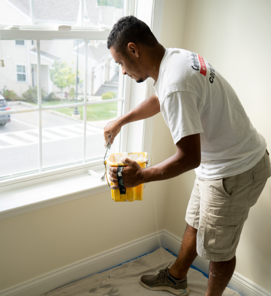 interior painter working on apartment window