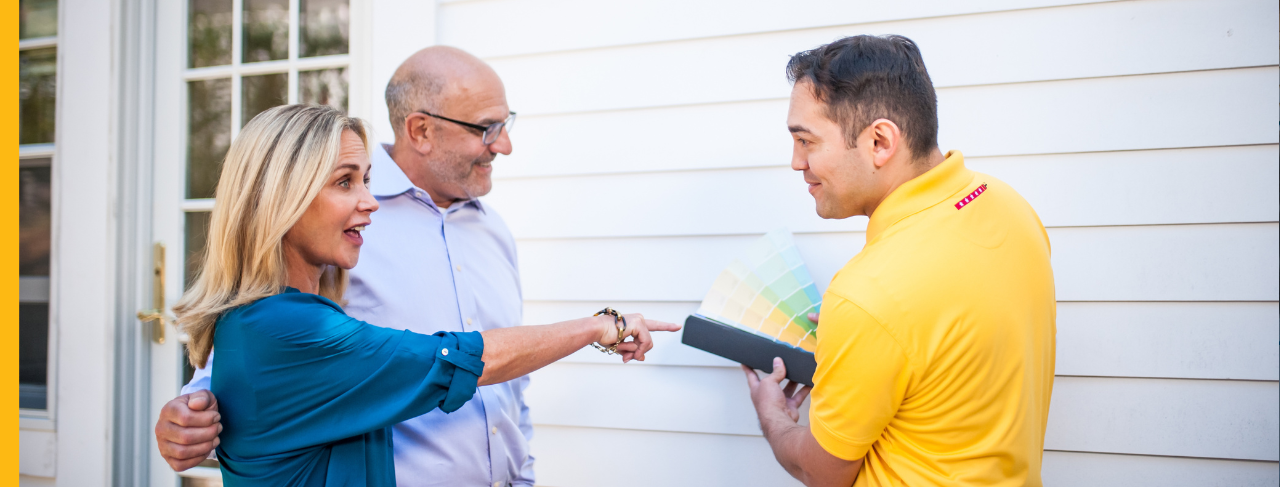 certapro painter with clients choosing exterior painting colors